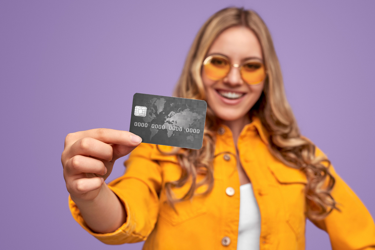 Happy bank client demonstrating credit card